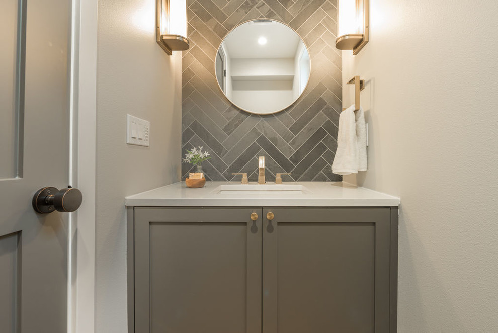 Design ideas for a small contemporary powder room in Seattle with shaker cabinets, grey cabinets, gray tile, porcelain tile, grey walls, light hardwood floors, an undermount sink, solid surface benchtops and beige floor.