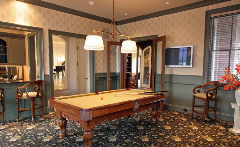 Arts and crafts enclosed family room in New York with a game room, beige walls, carpet and a wall-mounted tv.