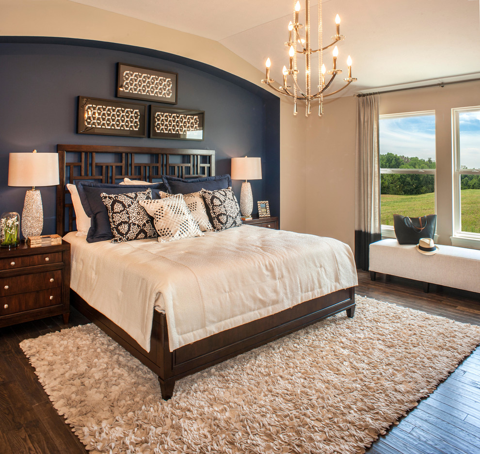 This is an example of a transitional master bedroom in Other with multi-coloured walls, dark hardwood floors and brown floor.