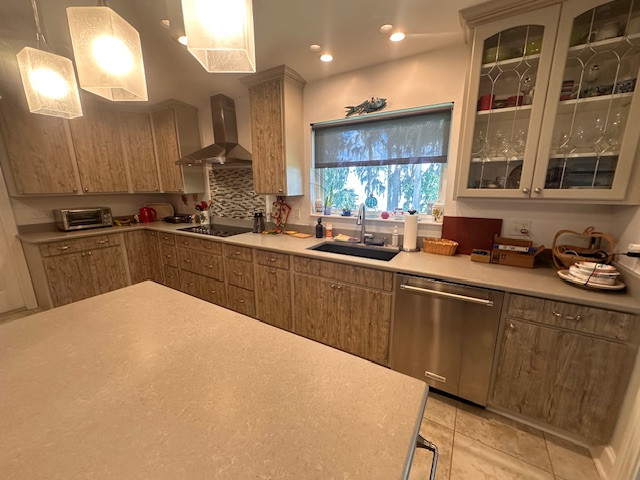 Inspiration for a large l-shaped eat-in kitchen remodel with an undermount sink, flat-panel cabinets, medium tone wood cabinets, stainless steel appliances and an island