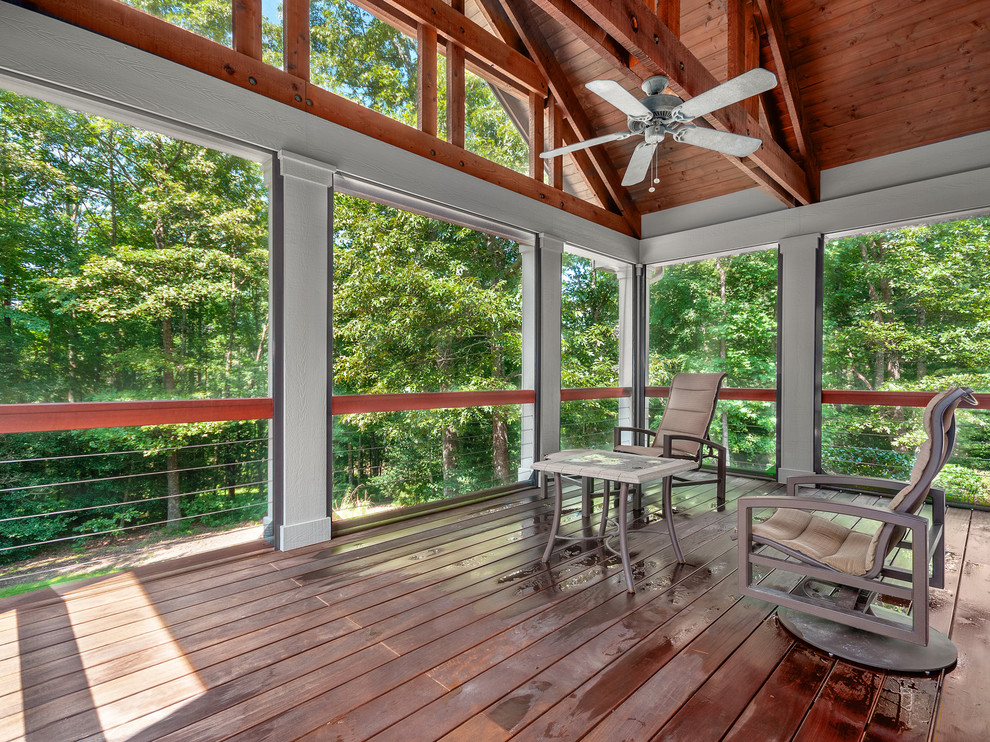 Example of a mid-sized arts and crafts medium tone wood floor and brown floor sunroom design with a standard ceiling