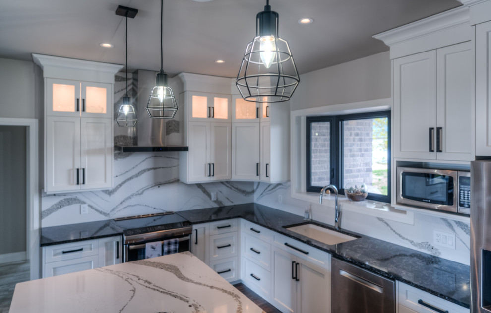 Inspiration for a transitional eat-in kitchen remodel with shaker cabinets, white cabinets, stainless steel appliances and an island