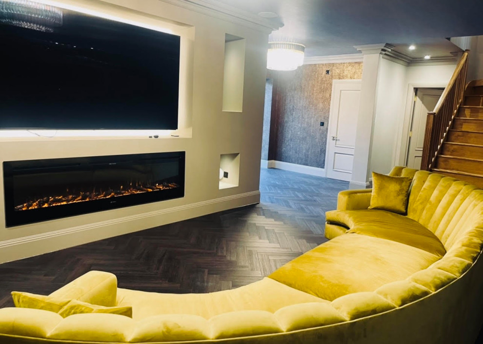 Inspiration for a large modern living room in Kent with a home bar, brown walls, dark hardwood flooring, a built-in media unit, black floors, a wallpapered ceiling and wallpapered walls.