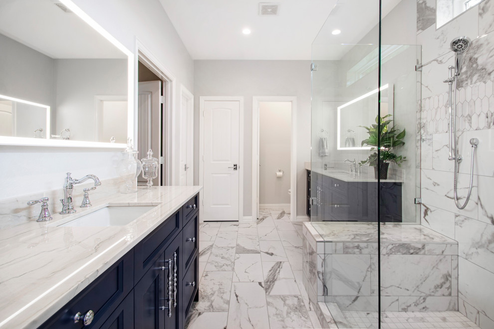 Design ideas for a mid-sized transitional master bathroom in Dallas with recessed-panel cabinets, blue cabinets, a corner shower, a two-piece toilet, black and white tile, marble, grey walls, marble floors, an undermount sink, quartzite benchtops, grey floor, a hinged shower door, white benchtops, a shower seat, a double vanity and a built-in vanity.