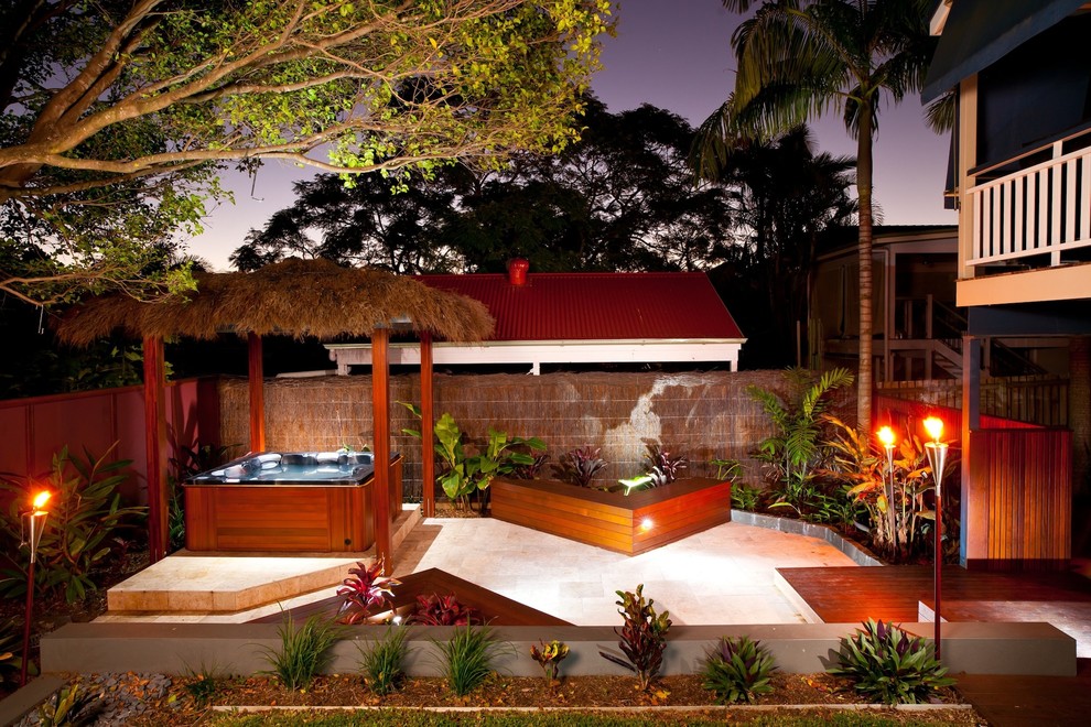 Design ideas for a tropical patio in Brisbane with no cover.