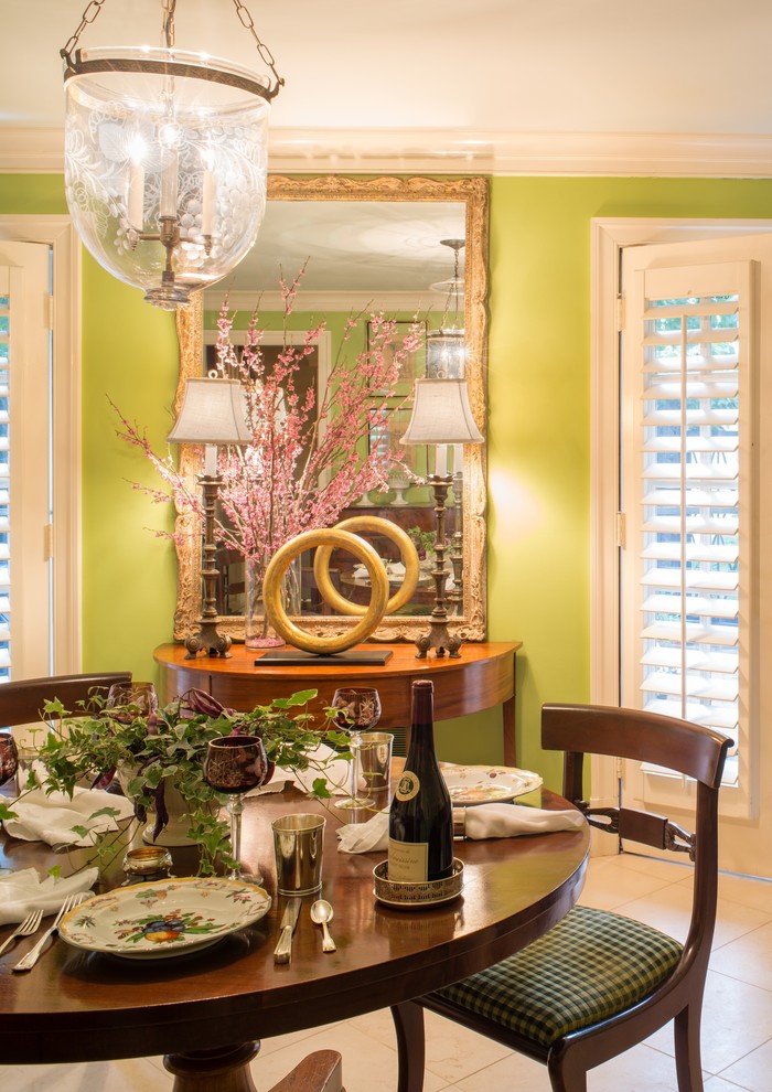 Inspiration for a traditional dining room in DC Metro with green walls and limestone floors.