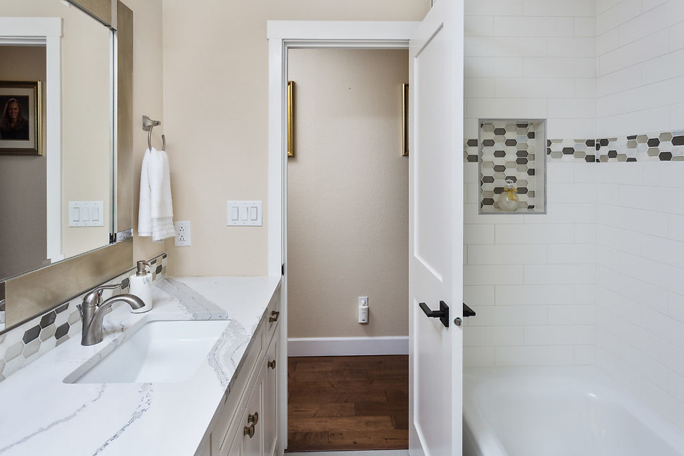 Inspiration for a transitional bathroom remodel with shaker cabinets, white cabinets, beige walls, an undermount sink and quartz countertops