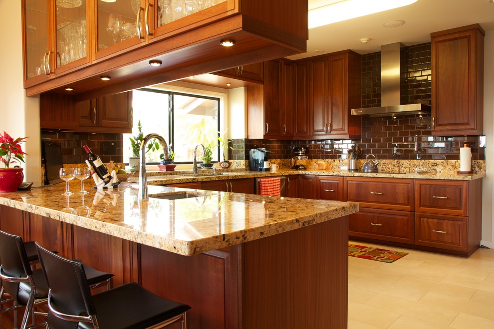 Design ideas for a mid-sized tropical u-shaped kitchen in Hawaii with an undermount sink, shaker cabinets, dark wood cabinets, granite benchtops, yellow splashback, stone slab splashback, stainless steel appliances, ceramic floors and a peninsula.