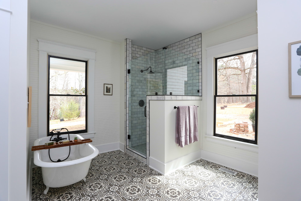 Design ideas for a large country master bathroom in Raleigh with furniture-like cabinets, dark wood cabinets, engineered quartz benchtops, a claw-foot tub, a corner shower, a two-piece toilet, black and white tile, marble, white walls, porcelain floors, an undermount sink, white floor, a hinged shower door and white benchtops.