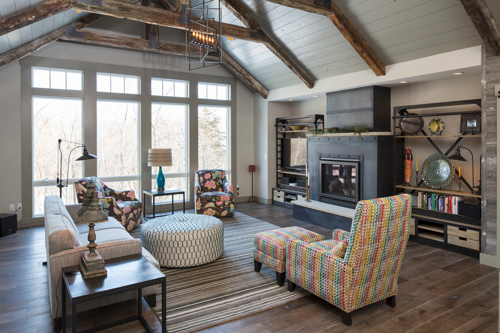 This is an example of a country open concept family room in Minneapolis with dark hardwood floors, a standard fireplace and a built-in media wall.
