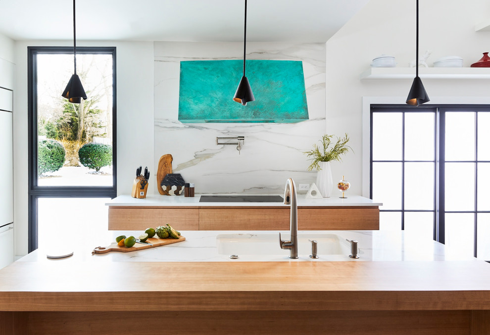 Photo of a mid-sized contemporary l-shaped separate kitchen in Philadelphia with an undermount sink, flat-panel cabinets, light wood cabinets, solid surface benchtops, window splashback, panelled appliances, porcelain floors, with island and multi-coloured benchtop.
