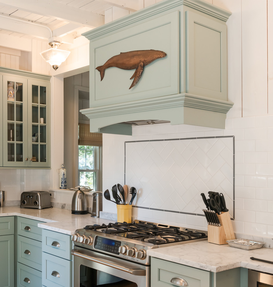 Mid-sized beach style eat-in kitchen in Chicago with an undermount sink, flat-panel cabinets, green cabinets, marble benchtops, white splashback, subway tile splashback, stainless steel appliances, light hardwood floors and multiple islands.