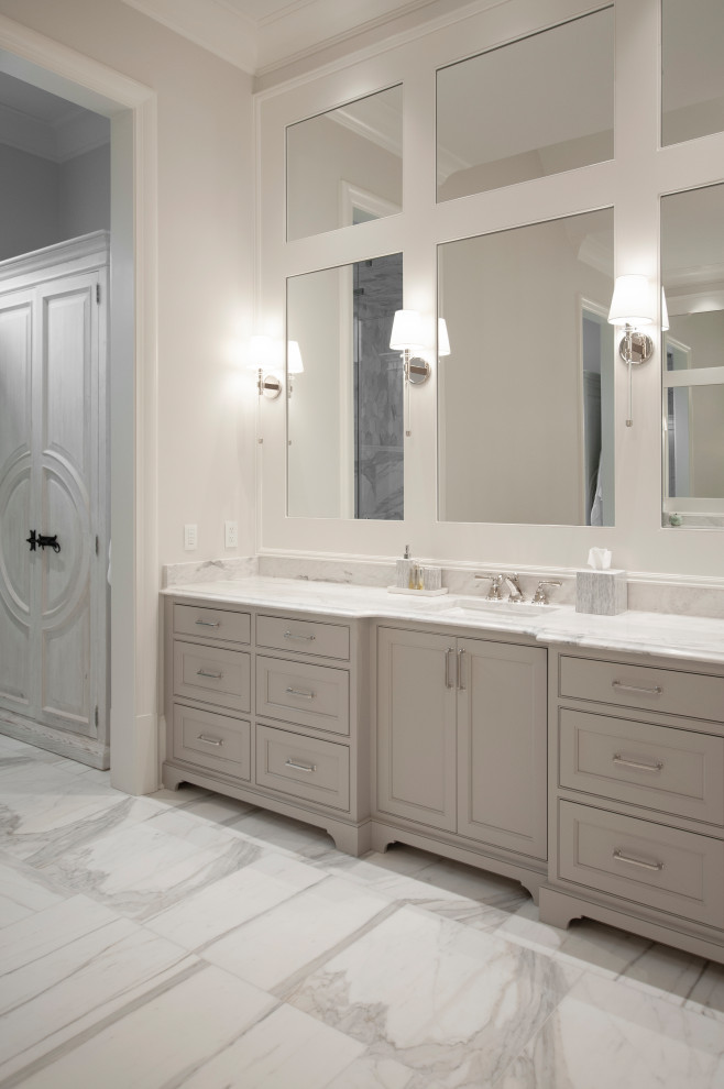 Design ideas for an expansive traditional master bathroom in Nashville with beaded inset cabinets, beige cabinets, an alcove shower, beige tile, marble, beige walls, marble floors, an undermount sink, marble benchtops, white floor, a hinged shower door, white benchtops, a double vanity and a built-in vanity.
