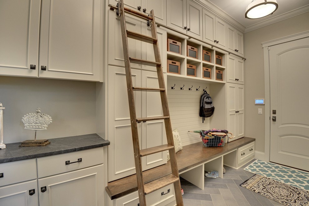 This is an example of a large transitional mudroom in Minneapolis with beige walls, a single front door and a white front door.
