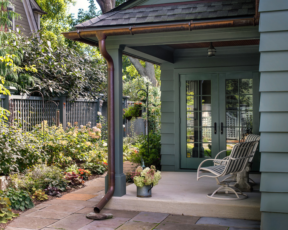 Inspiration for a traditional verandah in Detroit with concrete slab and a roof extension.