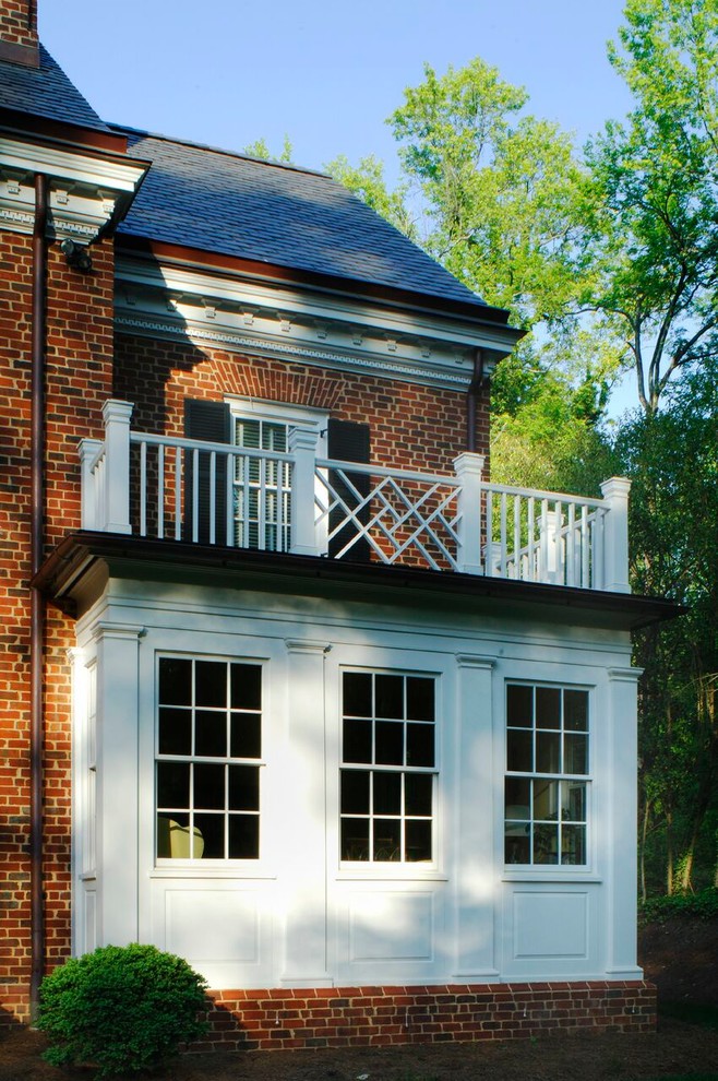 Design ideas for a large traditional three-storey brick red house exterior in Raleigh.
