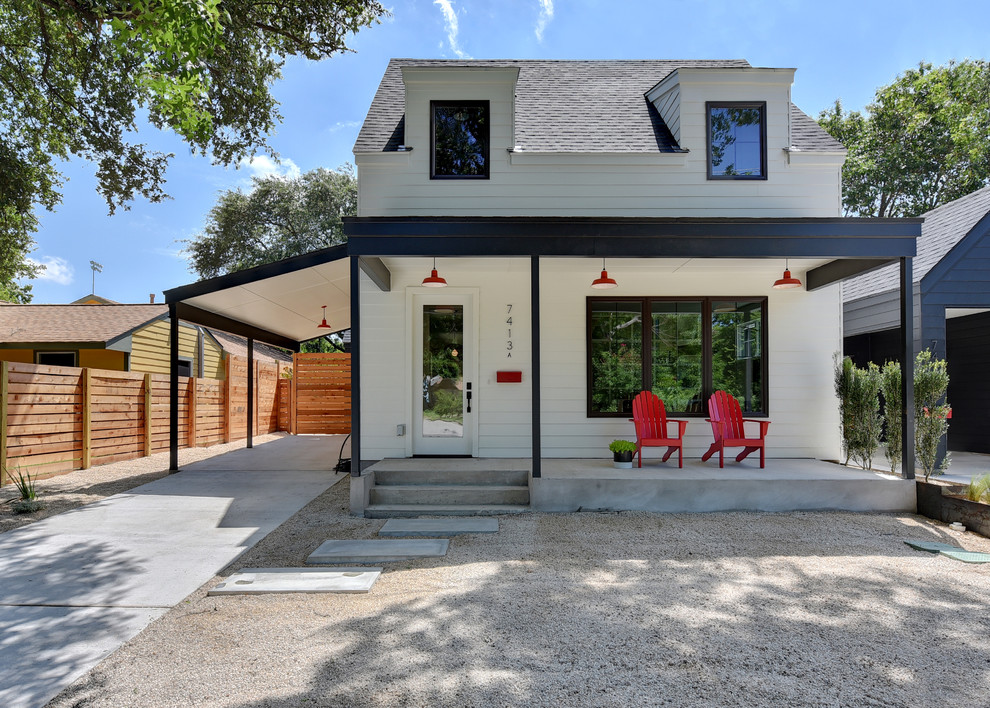 Inspiration for a small country two-storey white exterior in Austin with wood siding and a gable roof.