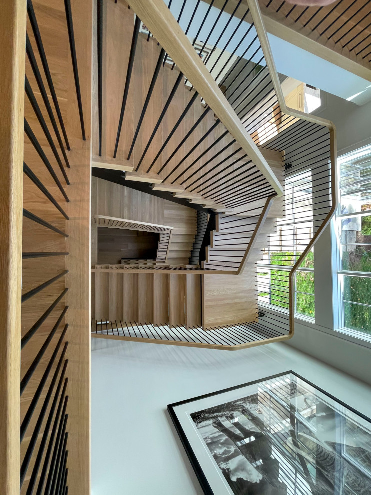 Exemple d'un très grand escalier flottant moderne avec des marches en bois, un garde-corps en matériaux mixtes et du lambris de bois.