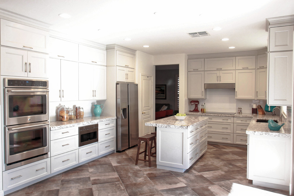 Eat-in kitchen - mid-sized transitional u-shaped porcelain tile and gray floor eat-in kitchen idea in Phoenix with a double-bowl sink, shaker cabinets, gray cabinets, granite countertops, white backsplash, subway tile backsplash, stainless steel appliances, an island and white countertops