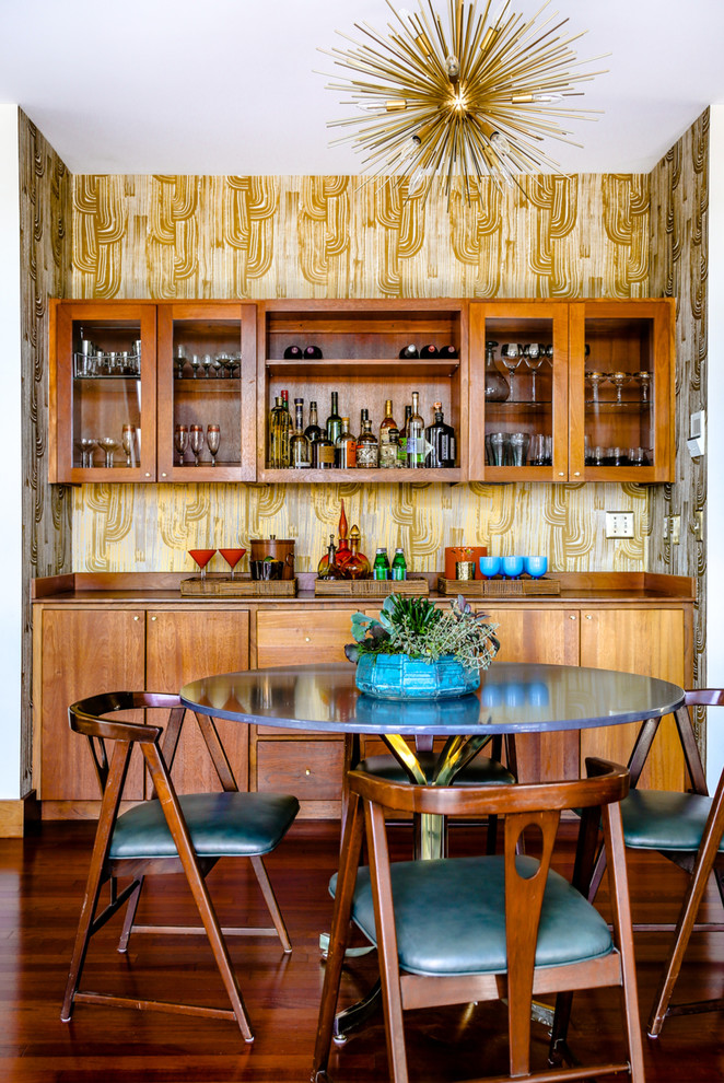 Mid-sized midcentury single-wall home bar in Portland Maine with flat-panel cabinets, medium wood cabinets and wood benchtops.