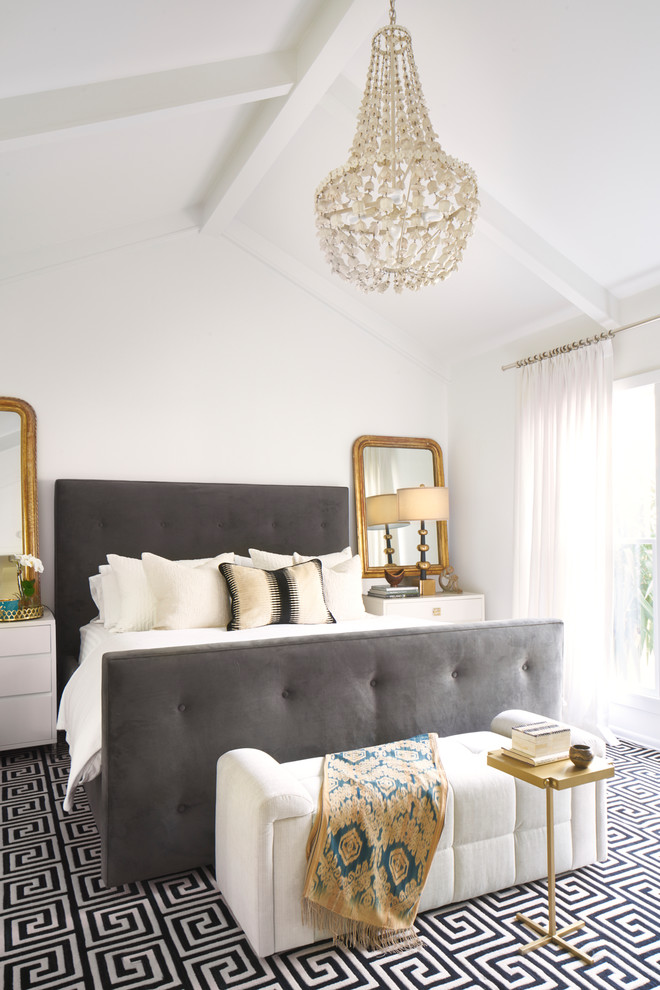 This is an example of a transitional master bedroom in Austin with white walls.
