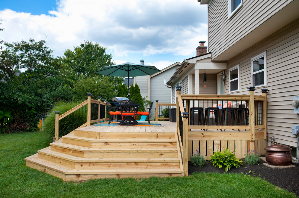 Example of a mid-sized minimalist backyard deck design in Columbus with no cover
