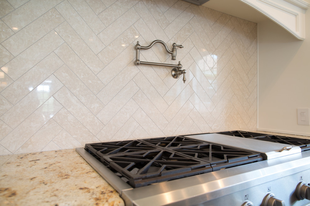 Design ideas for a traditional kitchen in Houston with beige splashback and stone tile splashback.