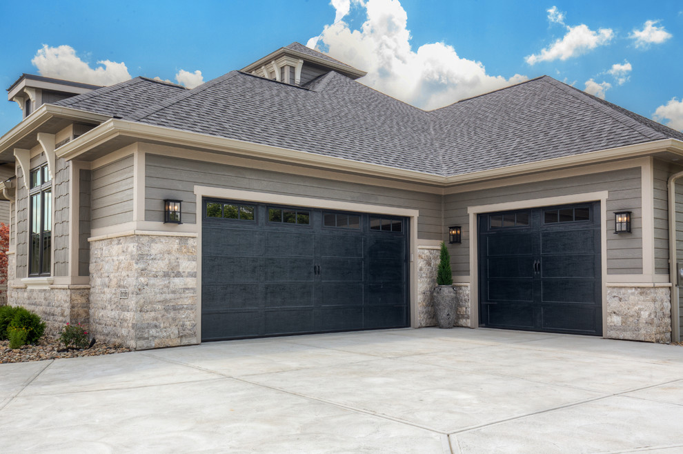 Photo of a mid-sized transitional attached two-car garage in Other.