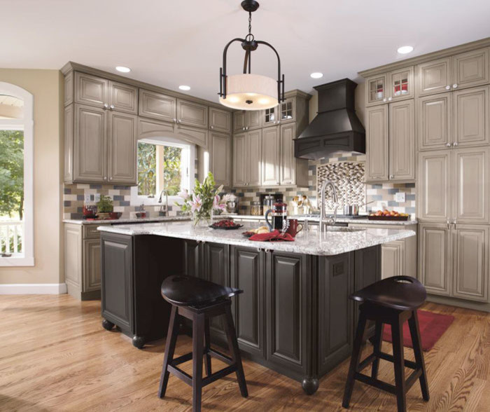 Inspiration for a large transitional l-shaped medium tone wood floor and brown floor eat-in kitchen remodel in Denver with an undermount sink, raised-panel cabinets, gray cabinets, quartzite countertops, multicolored backsplash, ceramic backsplash, paneled appliances and an island