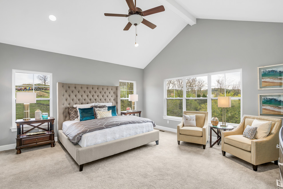 This is an example of a mid-sized transitional master bedroom in St Louis with grey walls, carpet, no fireplace and brown floor.