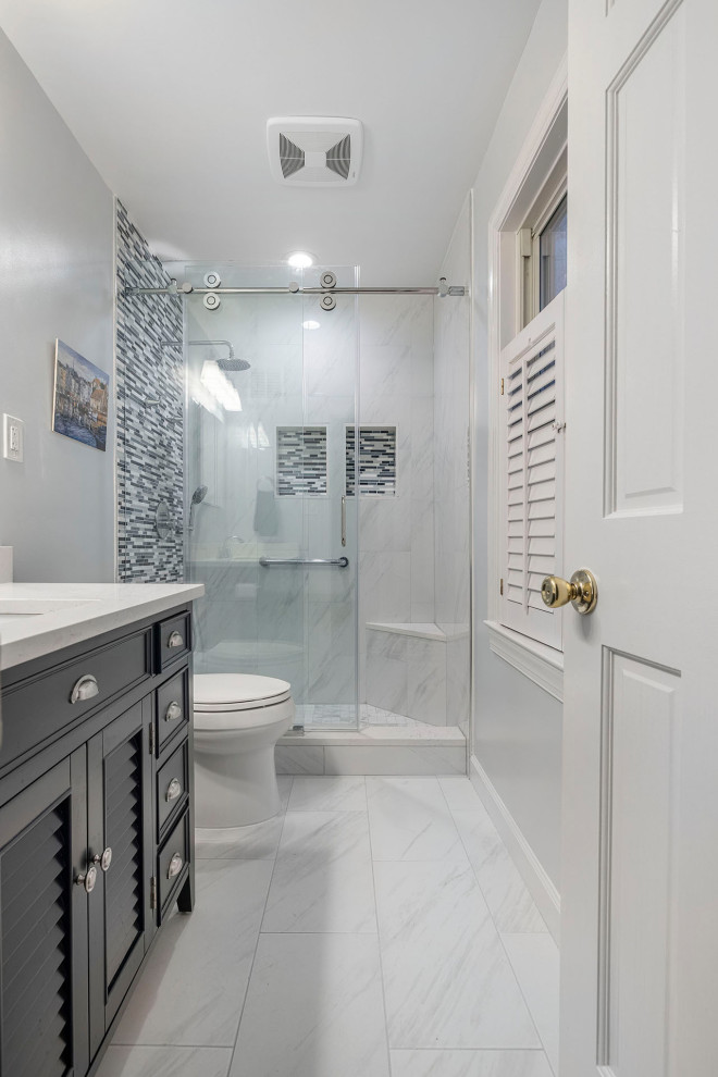 Inspiration for a mid-sized contemporary master multicolored tile and mosaic tile porcelain tile, white floor and single-sink bathroom remodel in DC Metro with furniture-like cabinets, blue cabinets, a two-piece toilet, blue walls, an undermount sink, quartz countertops, white countertops, a niche and a freestanding vanity