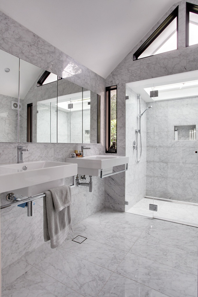 Photo of a large contemporary master bathroom in Sydney with a wall-mount sink, a curbless shower, white tile, white cabinets, a one-piece toilet, marble, multi-coloured walls, marble floors and quartzite benchtops.