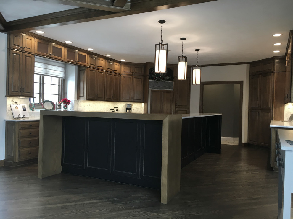 Large transitional u-shaped medium tone wood floor open concept kitchen photo with an undermount sink, recessed-panel cabinets, distressed cabinets, quartz countertops, multicolored backsplash, mosaic tile backsplash, stainless steel appliances and an island