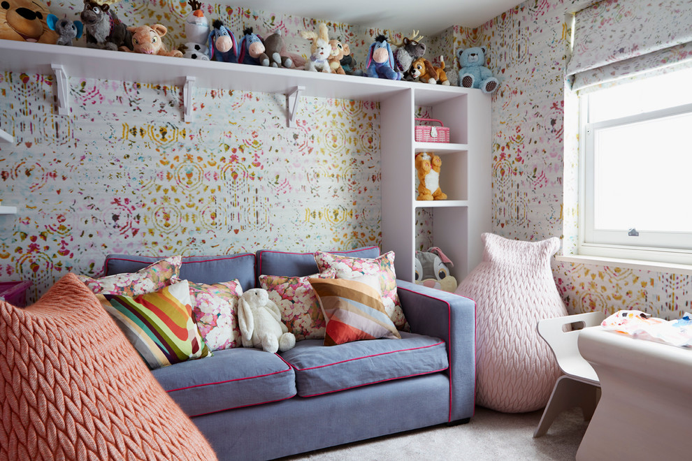 This is an example of a contemporary kids' playroom for girls and kids 4-10 years old in London with multi-coloured walls and carpet.