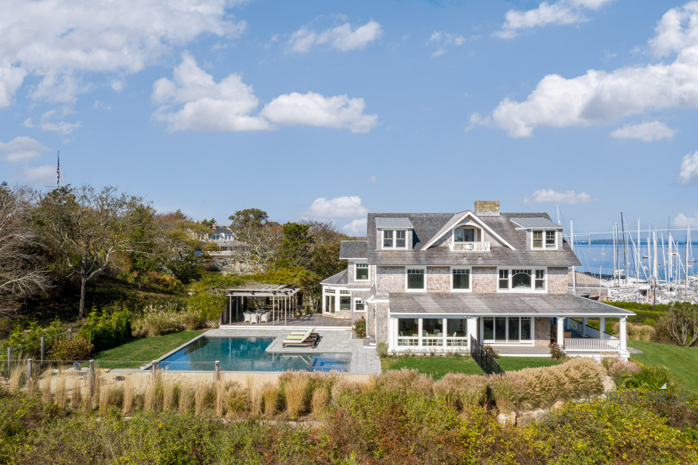 Large beach style gray four-story wood and shingle exterior home photo in Providence with a mixed material roof and a gray roof