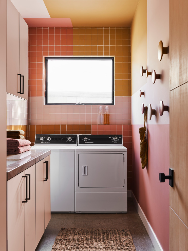 Inspiration for a retro l-shaped separated utility room in Orange County with a submerged sink, flat-panel cabinets, multi-coloured splashback, multi-coloured walls, concrete flooring, a side by side washer and dryer, grey floors and grey worktops.