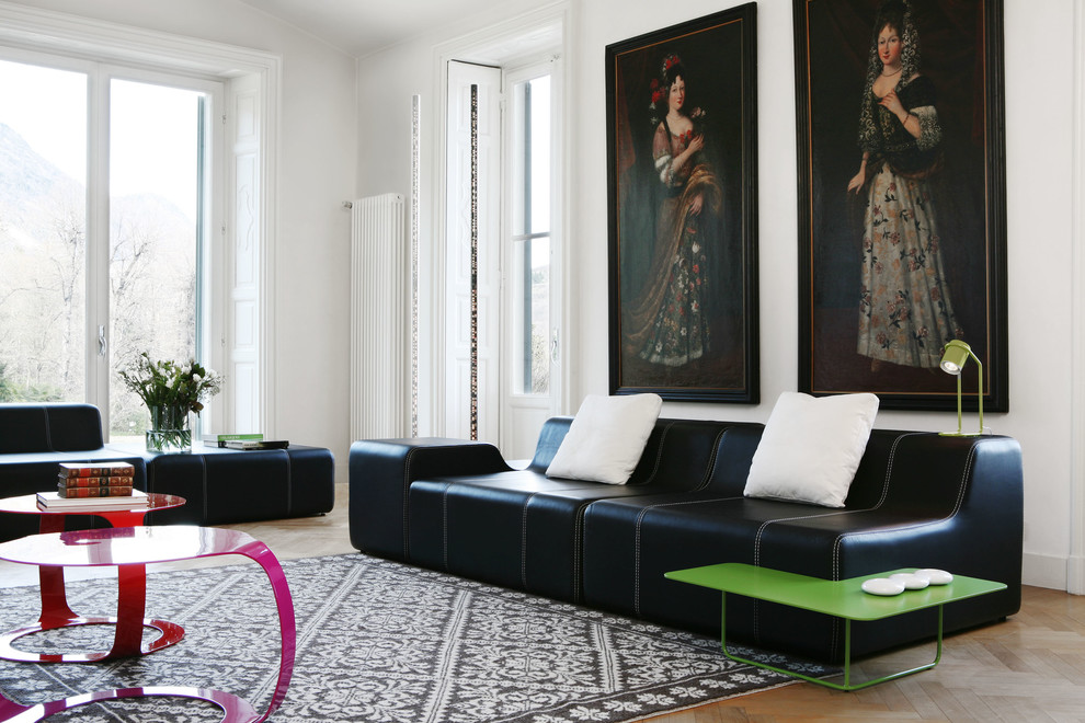 Inspiration for an expansive contemporary enclosed family room in Milan with white walls and medium hardwood floors.