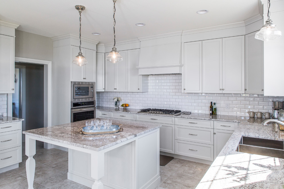 Enclosed kitchen - mid-sized transitional u-shaped gray floor enclosed kitchen idea with a double-bowl sink, shaker cabinets, white cabinets, white backsplash, subway tile backsplash, stainless steel appliances and an island