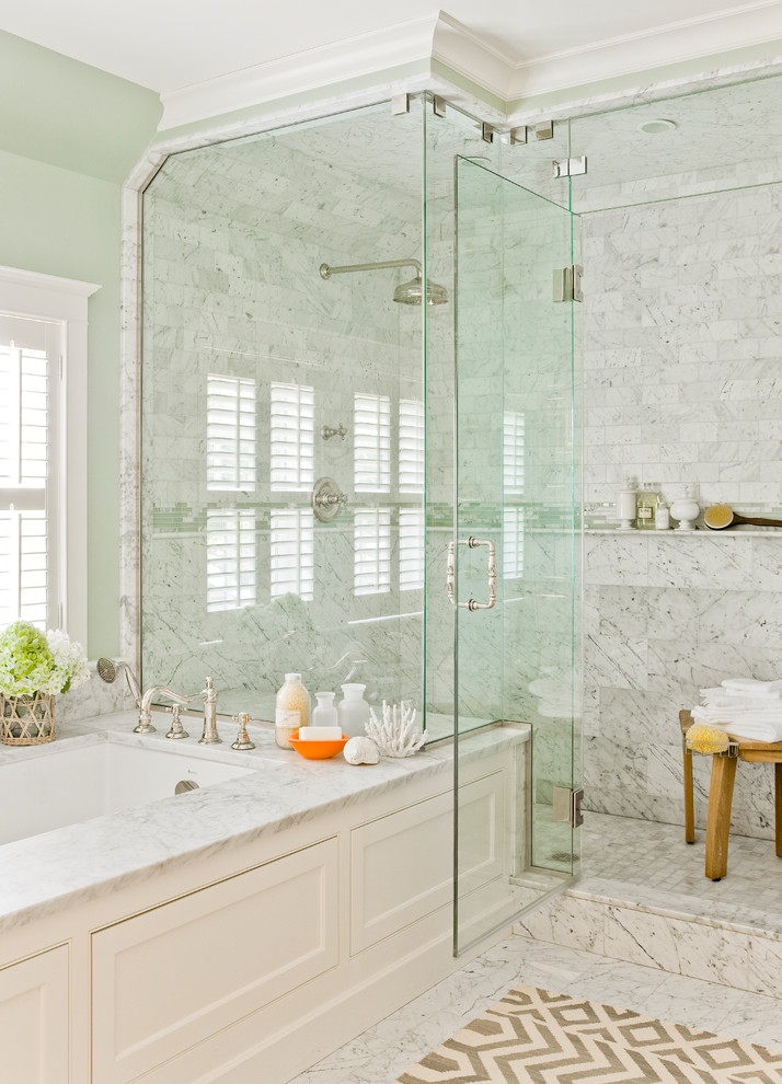 Design ideas for a traditional master bathroom in Boston with white cabinets, marble benchtops, an undermount tub, white tile, stone tile, green walls and marble floors.