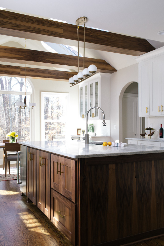 Inspiration for a large transitional l-shaped eat-in kitchen in Atlanta with a farmhouse sink, shaker cabinets, white cabinets, marble benchtops, white splashback, ceramic splashback, stainless steel appliances, dark hardwood floors and with island.