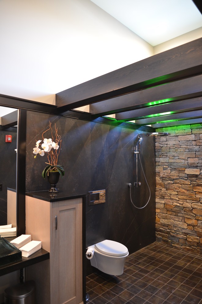 Inspiration for a large transitional master brown tile and ceramic tile ceramic tile and brown floor wet room remodel in Chicago with recessed-panel cabinets, light wood cabinets, a wall-mount toilet, brown walls, a vessel sink and granite countertops