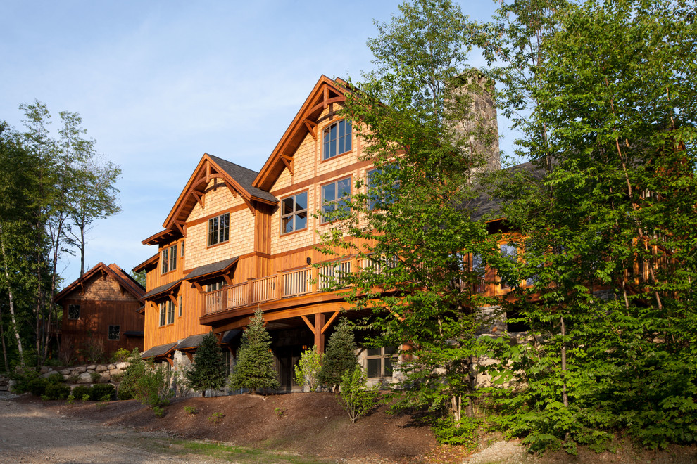 This is an example of a large arts and crafts three-storey brown exterior in Burlington with wood siding.