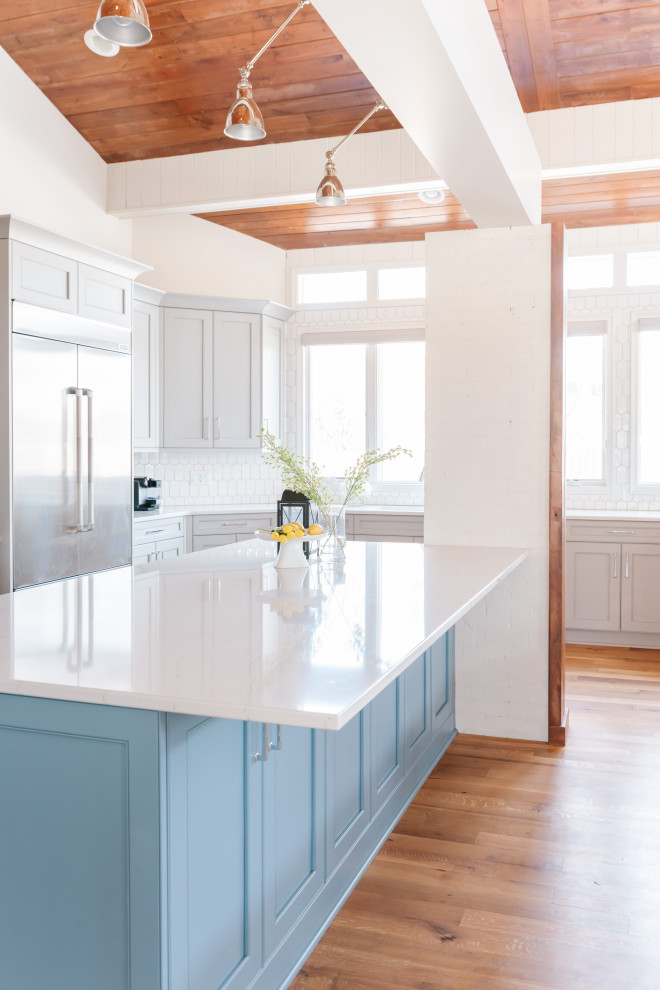 Example of a large transitional kitchen design in Omaha with an island
