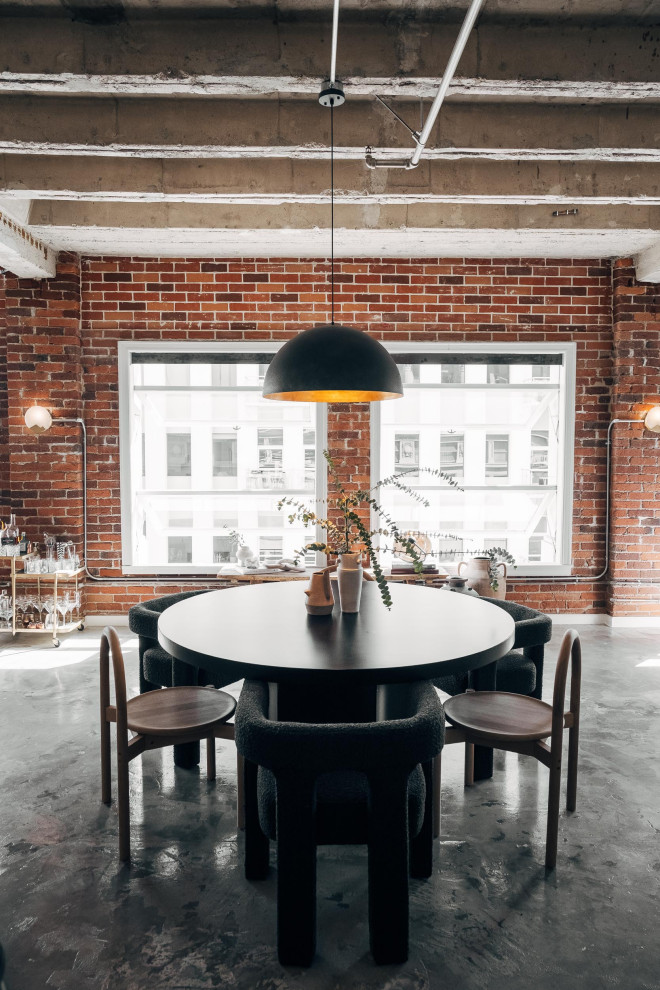 Design ideas for a mid-sized industrial open plan dining in Other with multi-coloured walls, concrete floors, no fireplace, grey floor, exposed beam and brick walls.