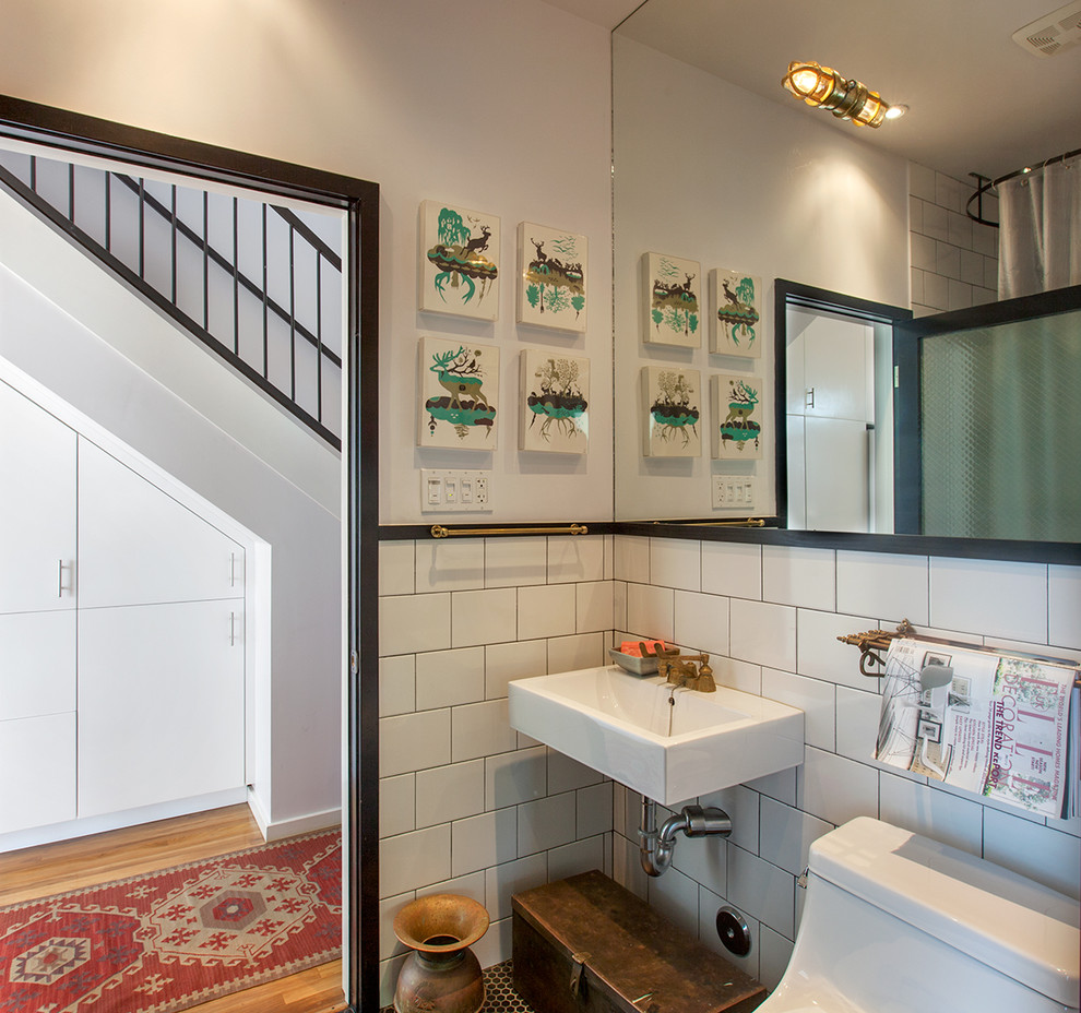 Photo of a small modern bathroom in Los Angeles with subway tile, a wall-mount sink, a one-piece toilet, white tile and white walls.