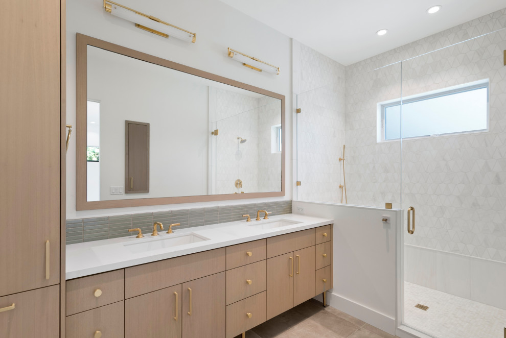 This is an example of a mid-sized contemporary 3/4 bathroom in San Francisco with flat-panel cabinets, light wood cabinets, an alcove shower, gray tile, marble, grey walls, an undermount sink, solid surface benchtops, a hinged shower door and white benchtops.