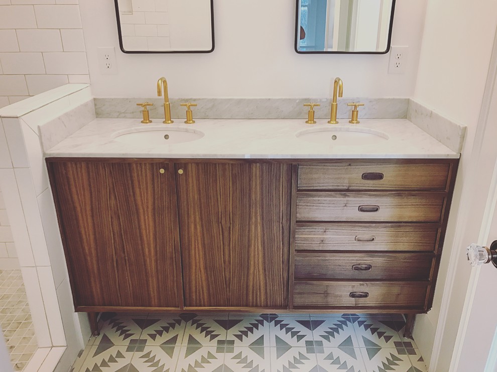 This is an example of a mid-sized midcentury master bathroom in Atlanta with flat-panel cabinets, medium wood cabinets, an open shower, a two-piece toilet, gray tile, ceramic tile, white walls, ceramic floors, an undermount sink and marble benchtops.
