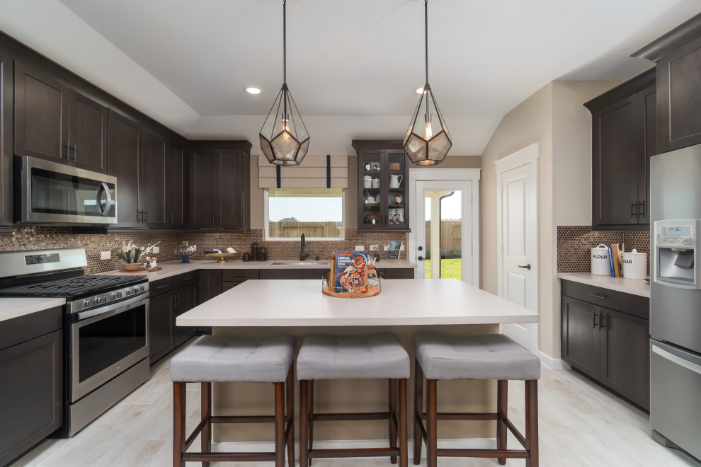 Mid-sized transitional light wood floor and beige floor eat-in kitchen photo in Houston with an undermount sink, recessed-panel cabinets, brown cabinets, solid surface countertops, brown backsplash, ceramic backsplash, stainless steel appliances, an island and white countertops
