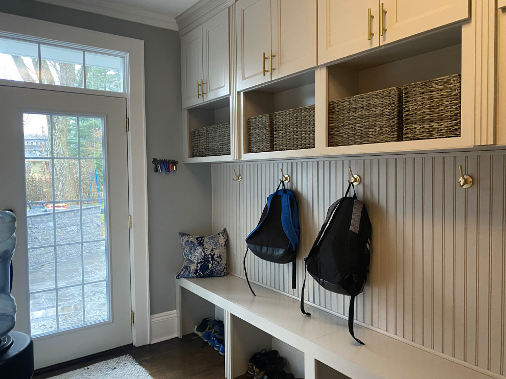 Photo of a small transitional mudroom in New York with grey walls, dark hardwood floors, a single front door and a glass front door.