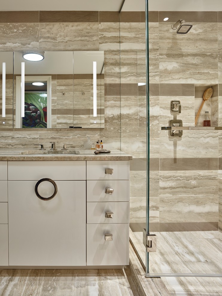Inspiration for a mid-sized contemporary master wet room bathroom in New York with flat-panel cabinets, white cabinets, an undermount tub, beige tile, porcelain tile, beige walls, limestone floors, an undermount sink, limestone benchtops and beige floor.